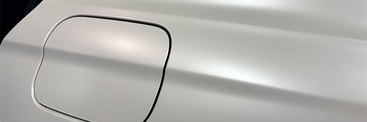 Satin Pearl White vehicle panel wrapped with Briteline ColorCAST color change vinyl film